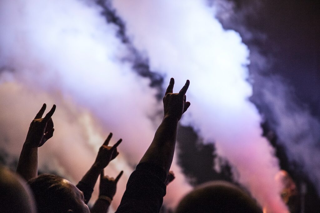 photo of persons doing rock hand sign metal concert music
