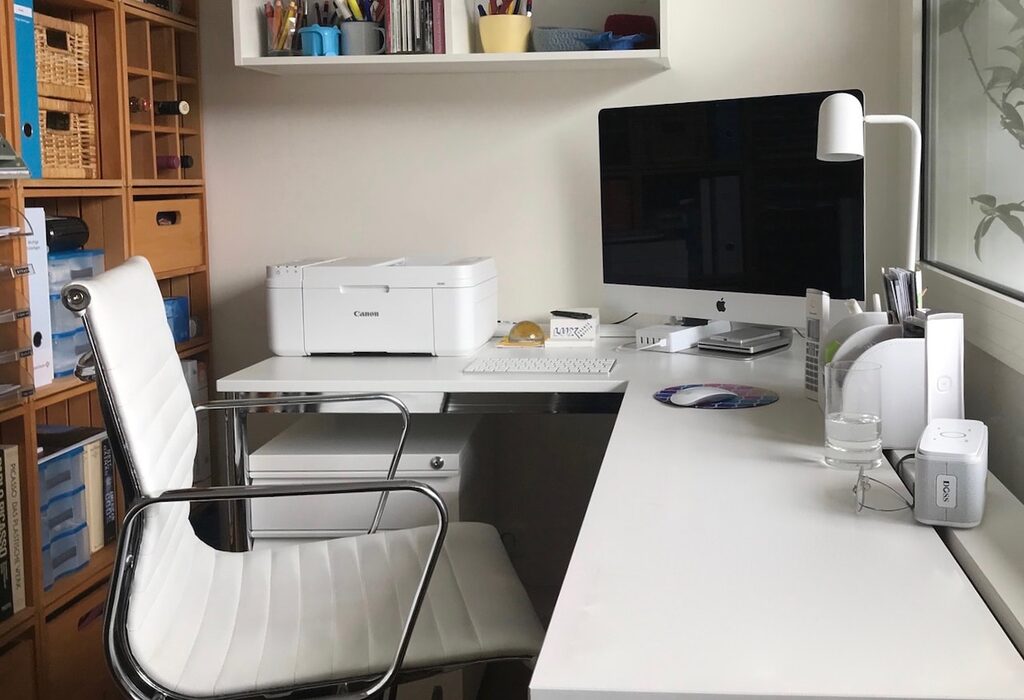 white printer on white table with computer