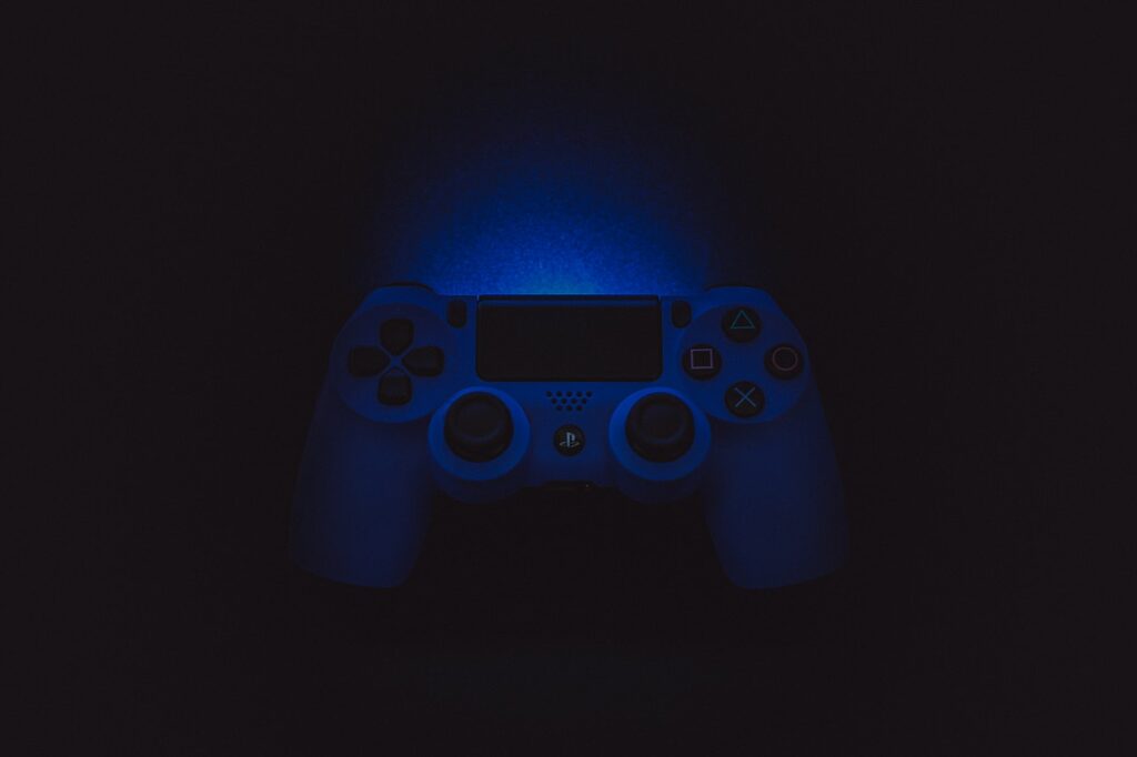 silhouette photography of Sony DualShock 4 Playstation console