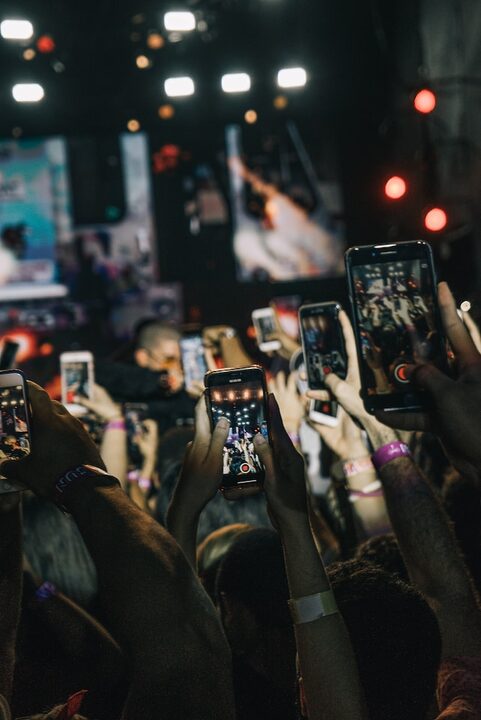 crowd taking video with smartphone camera