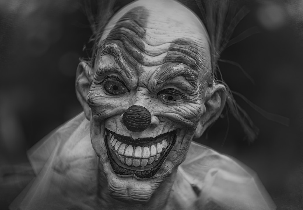 grayscale photography of person wearing clown mask horror thriller scary movie
