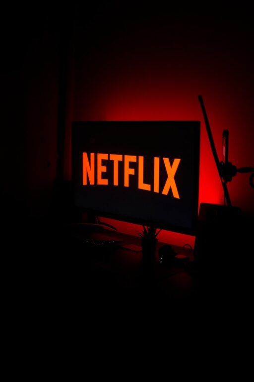 a red netflix sign sitting on top of a desk movie streaming